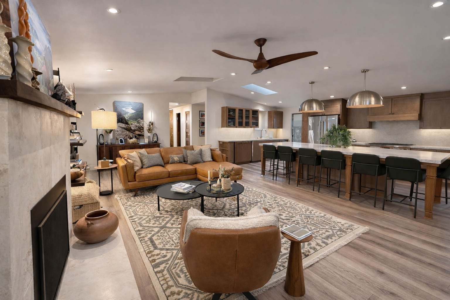 Modern living room staged by Snyder Atelier with leather seating and open kitchen